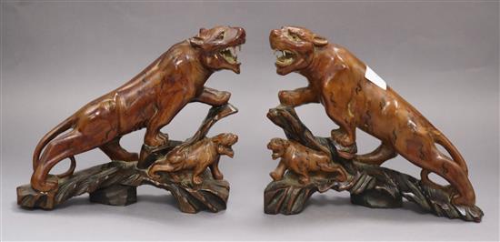 A pair of Chinese hardwood figures of tigers tallest 18cm